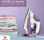 Purple and white Havells Husky steam iron next to folded clothes on a purple background
