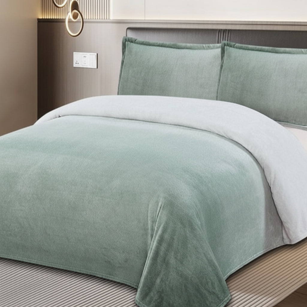 Green and white bedding set on a bed with a neutral headboard.