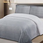 Gray bedding set on a bed in a bedroom setting