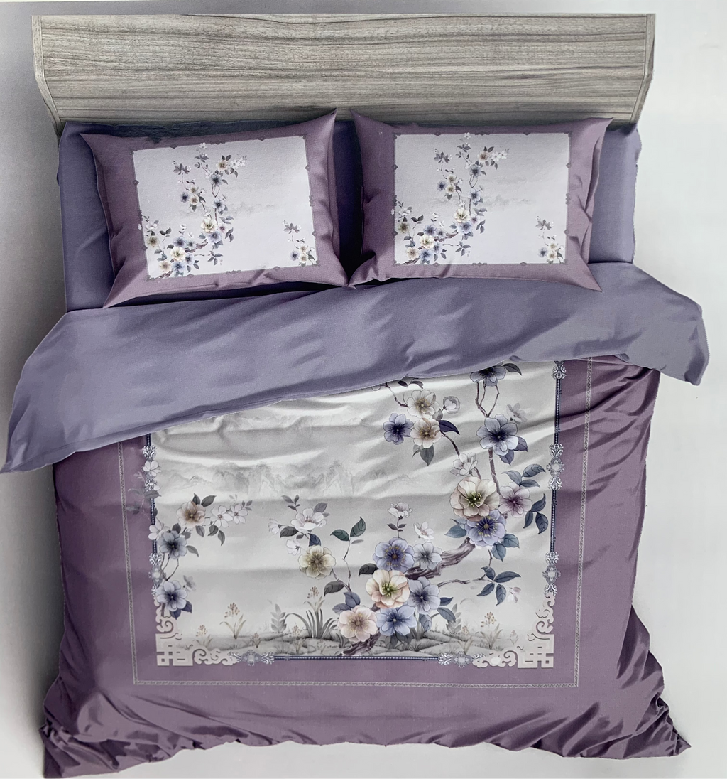 Floral bedding set with matching pillows on a bed, branded 'Rochelle France'.