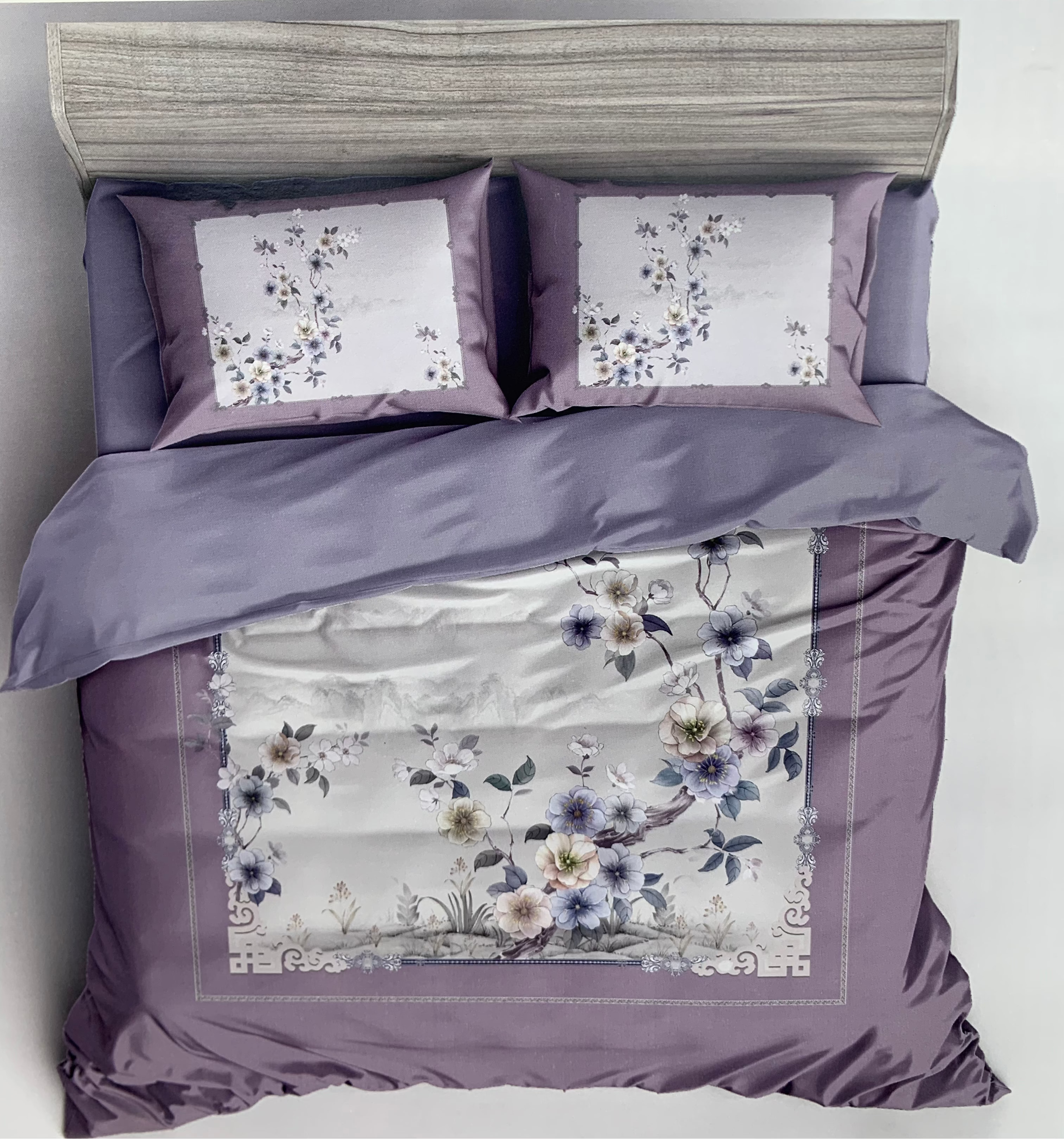 Floral bedding set with matching pillows on a bed, branded 'Rochelle France'.