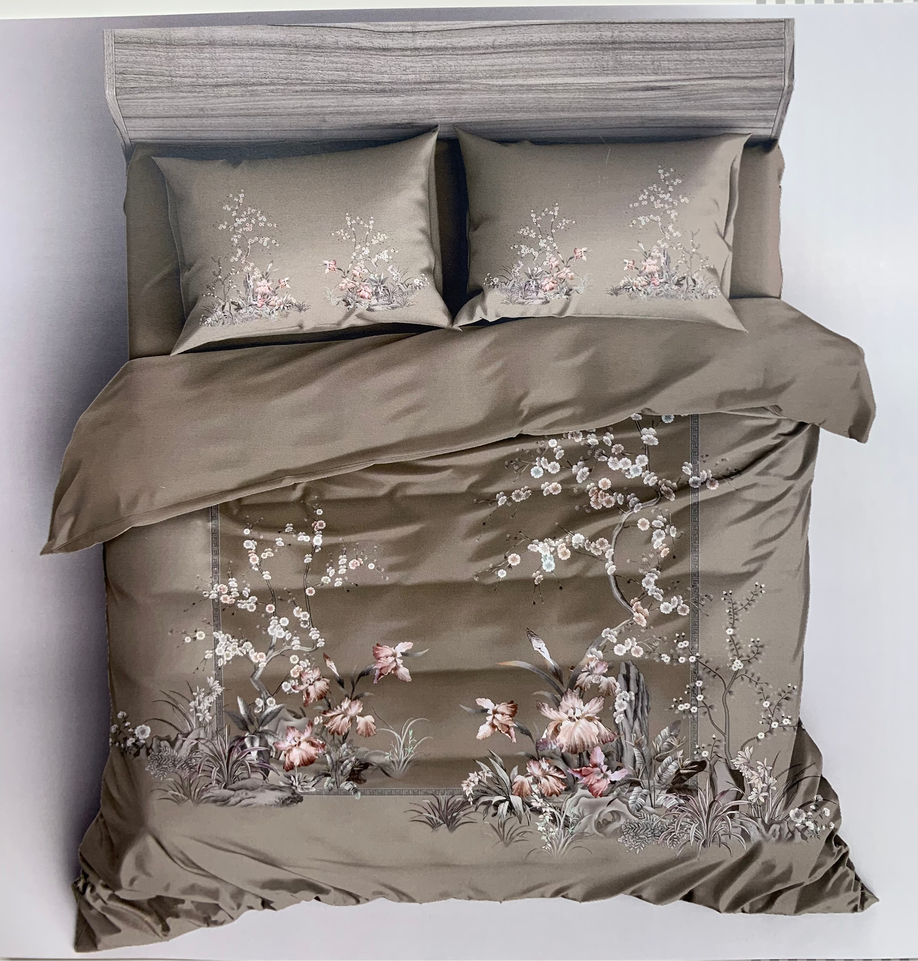 Bedding set with floral patterns on a bed against a white background, featuring the brand 'Rochelle France'.
