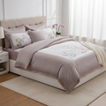 Neatly made bed with floral bedding in a bright bedroom