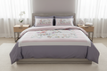 Bedding set with floral patterns and 'Rochelle France' branding.