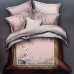Floral bedding set with decorative pillows on a bed, featuring the brand 'Rochelle France'.