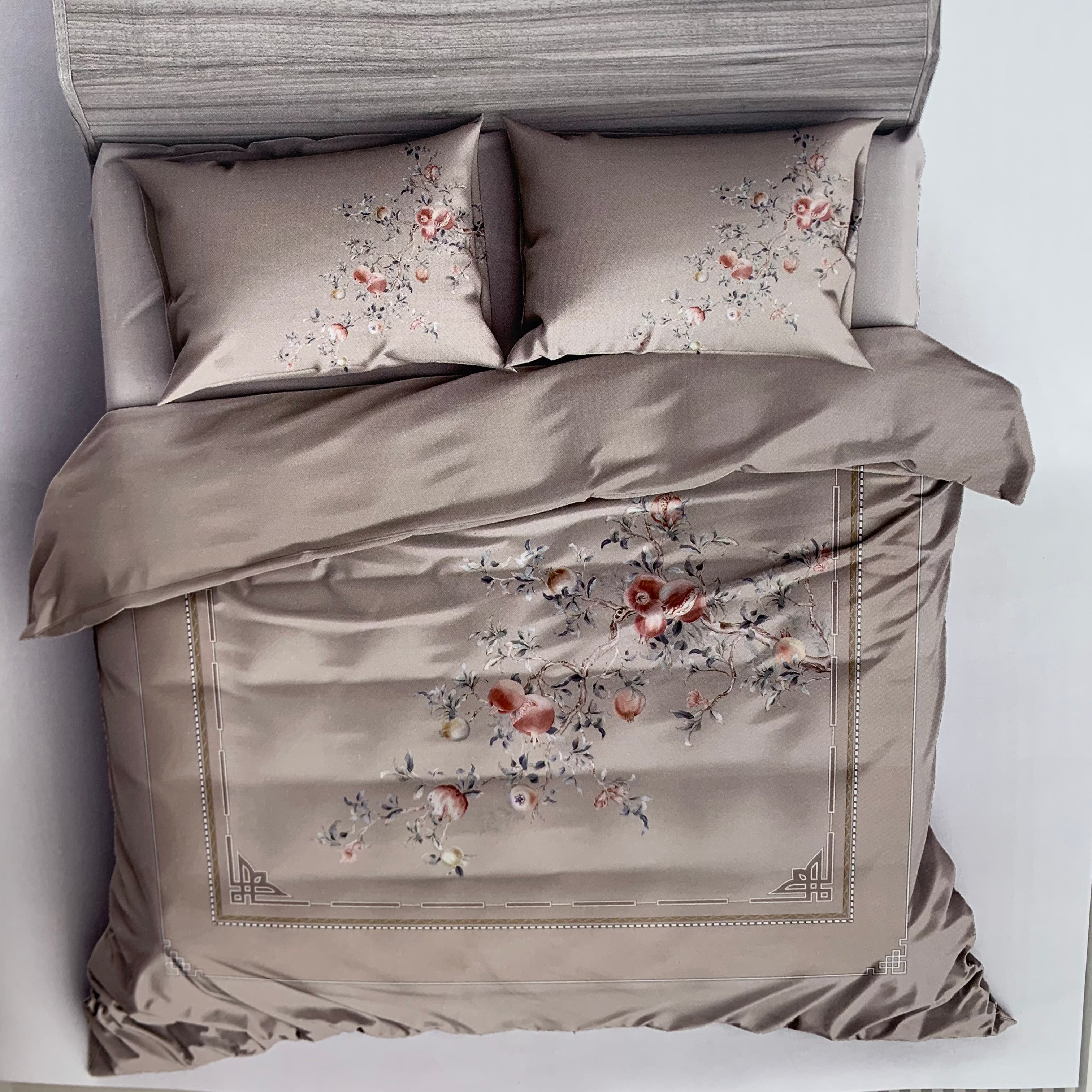 Bed with floral printed bedding and pillows, featuring the brand 'Rochelle France' on a white background.