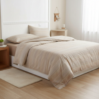 Bellagio Chelsea double layer yarn comforter on a bed with pillows and a side table.