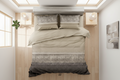 Beige and gray striped bedding set on a bed with a matching headboard.