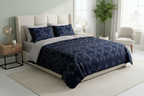 Bed with blue patterned bedding and pillows on a white background