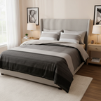 Bed with gray and white striped bedding on a plain background