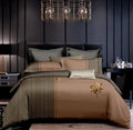 Brown and gray patterned bedding set on a bed in a darkly decorated bedroom.