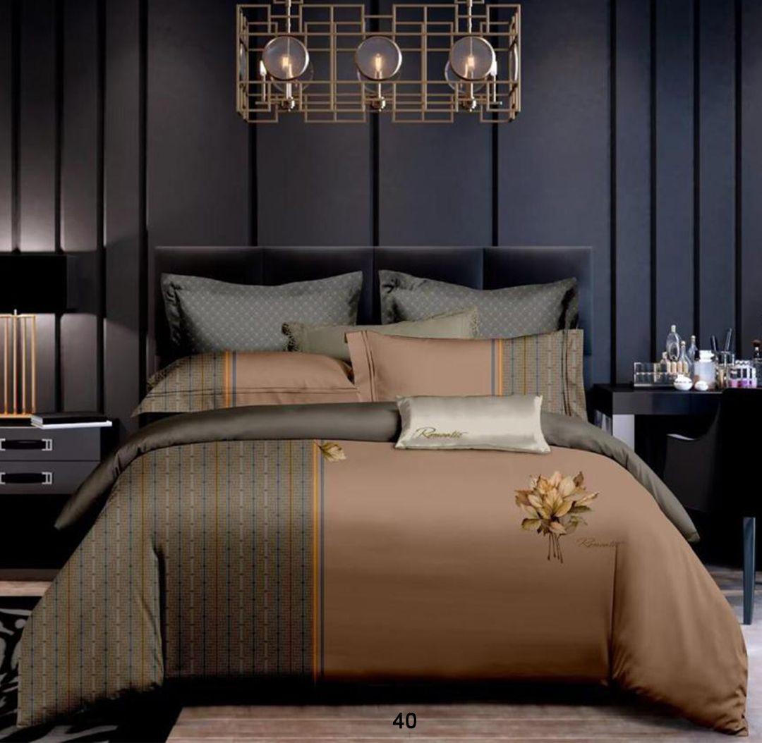 Brown and gray patterned bedding set on a bed in a darkly decorated bedroom.