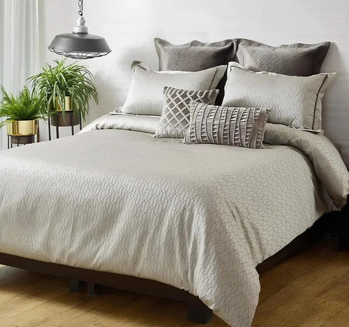 Neatly made bed with decorative pillows in a bedroom setting.